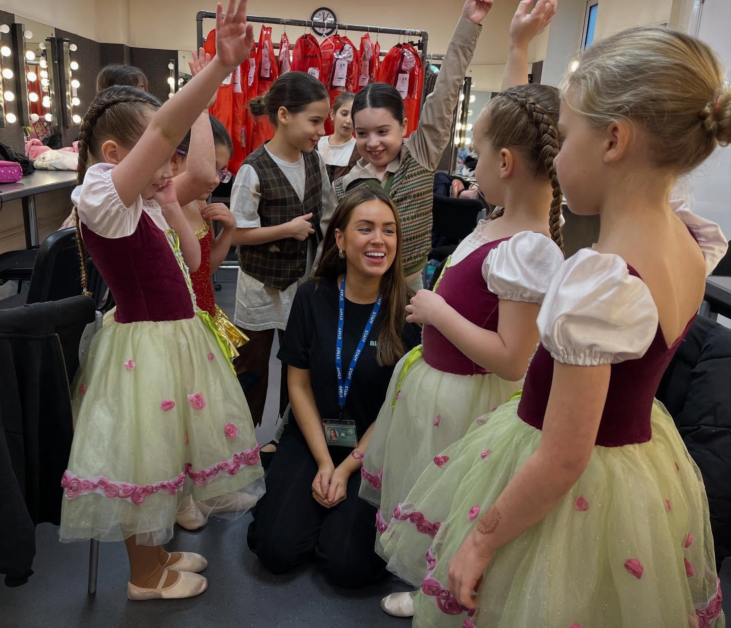 Big Time staff with young ballet performers backstage